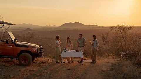 Small group gathers for sunset drinks during a South Africa safari experience