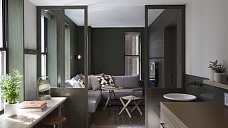 Rooftop terrace at AC Hotel Times Square with wooden seating, plants, and city skyline view