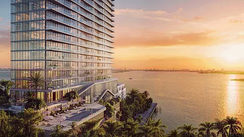 Aerial view of The Cove Residences at sunset overlooking Biscayne Bay and Miami skyline