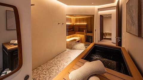 Private sauna and cold plunge suite with warm wood interiors and spa lighting