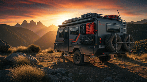 Off-road adventure vehicle parked on mountain trail at sunset with scenic peaks