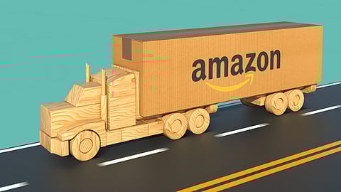 Wooden toy truck carrying Amazon box on road symbolizing ecommerce shipping