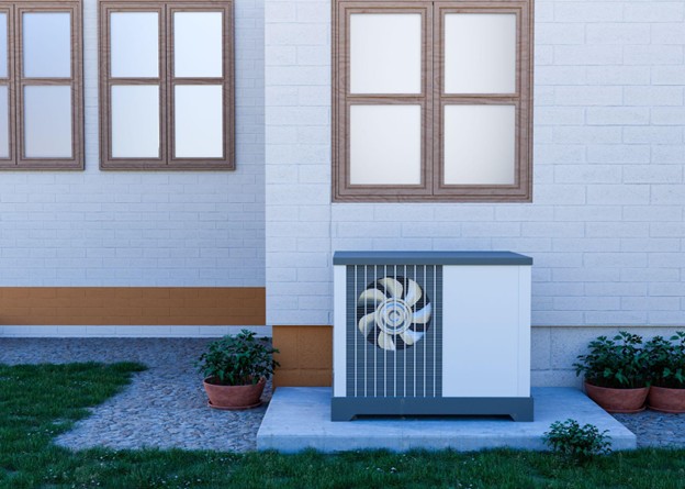 Outdoor heat pump unit beside home showing HVAC system for home maintenance