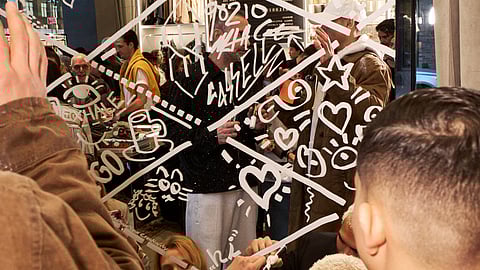 Efdot draws on mirrored walls during interactive Golden Goose event