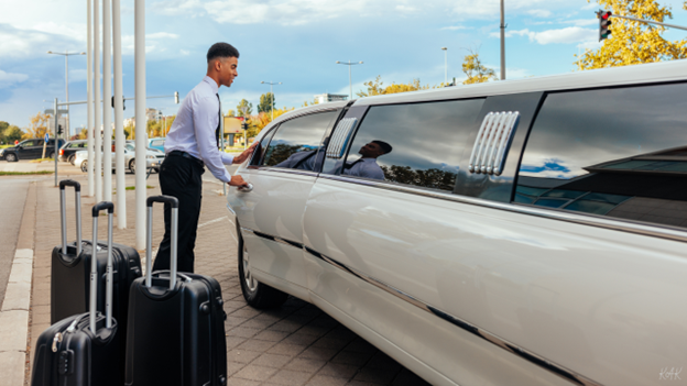 Man entering limousine with luggage, representing business travel and private transport