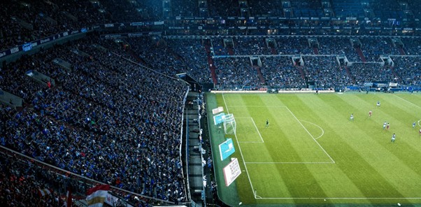 Crowded football stadium with fans watching match from above