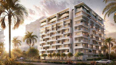 Modern mid-rise residential building with balconies and palm trees at sunset in Brickell Miami