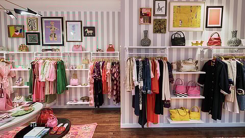 Frances Valentine boutique interior featuring colorful dresses, handbags, and framed artwork