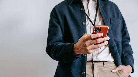 Person holding a smartphone illustrating SMS communication for marketing