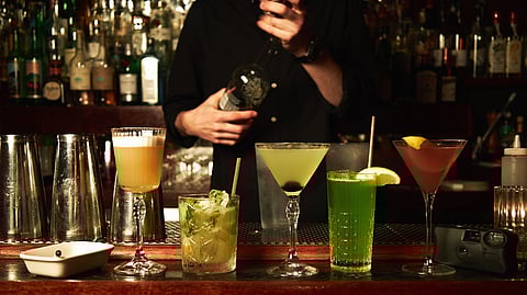 Guests enjoy a selection of martinis and retro cocktails at a dimly lit bar