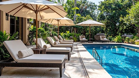 A serene pool surrounded by lush tropical gardens and mature trees