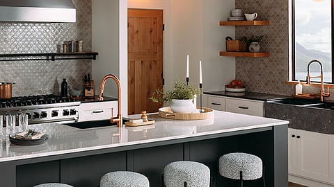 A plush, gray boucle upholstered seat and black steel legs