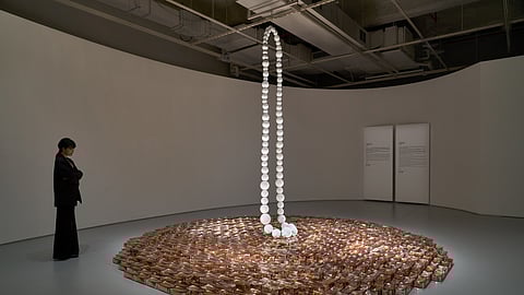 Jean-Michel Othoniel glass installation with suspended beads and pink glass brick base