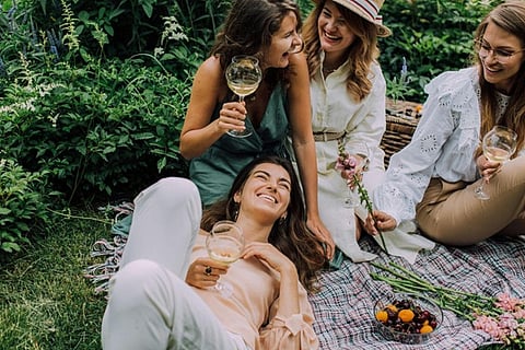 A group of female friends enjoying a leisure picnic