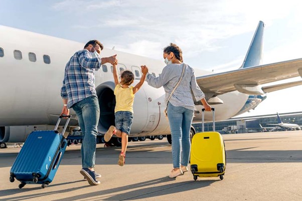 A family arriving at an airplane for a journey