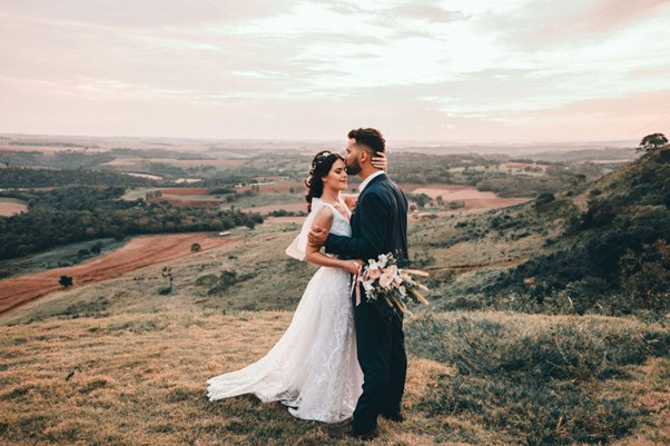 A couple during a wedding photography session on a hillside