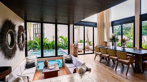 Modern villa living room with sunken seating and indoor plunge pool in Tulum