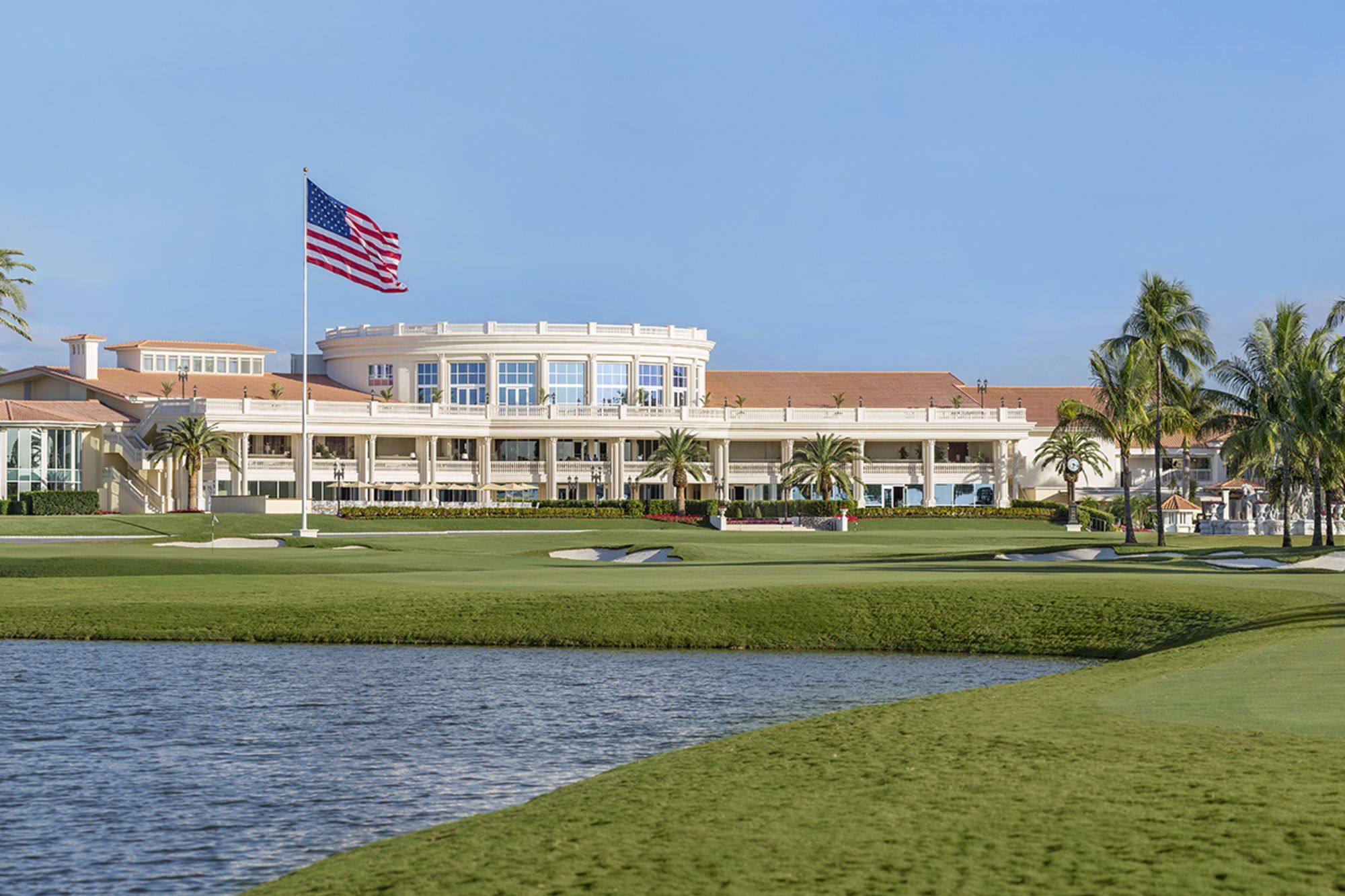 Trump National Doral clubhouse overlooking golf course and water with American flag