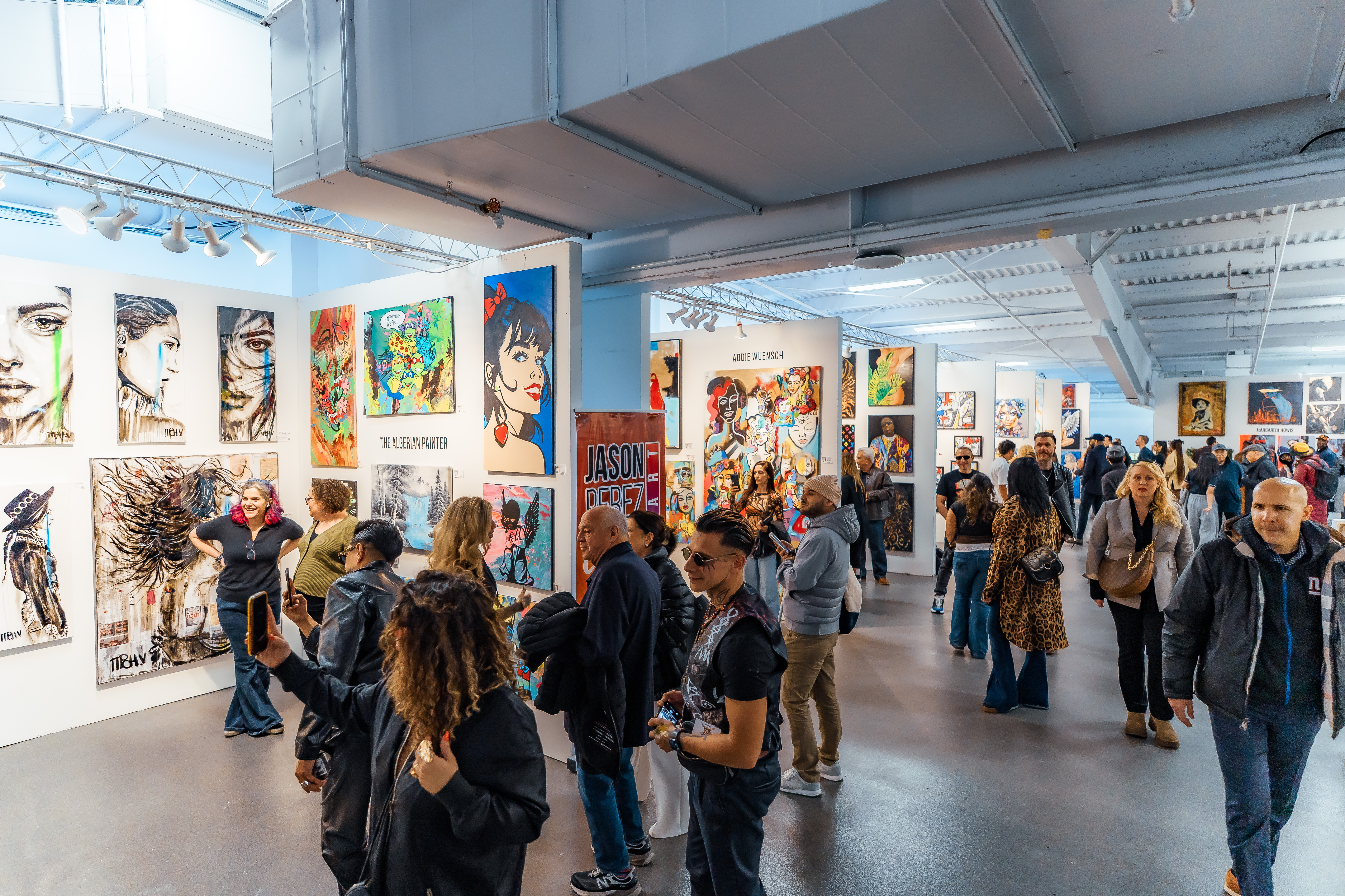 Visitors explore contemporary artworks and gallery booths at Artexpo New York