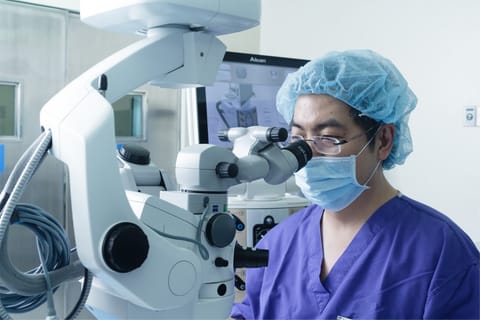A healthcare professional performing a surgical procedure