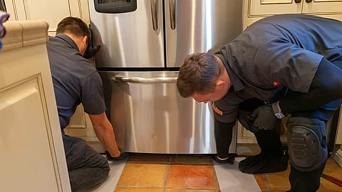 EPA-certified PrimeFix technicians repairing a Sub-Zero refrigerator in a San Francisco home
