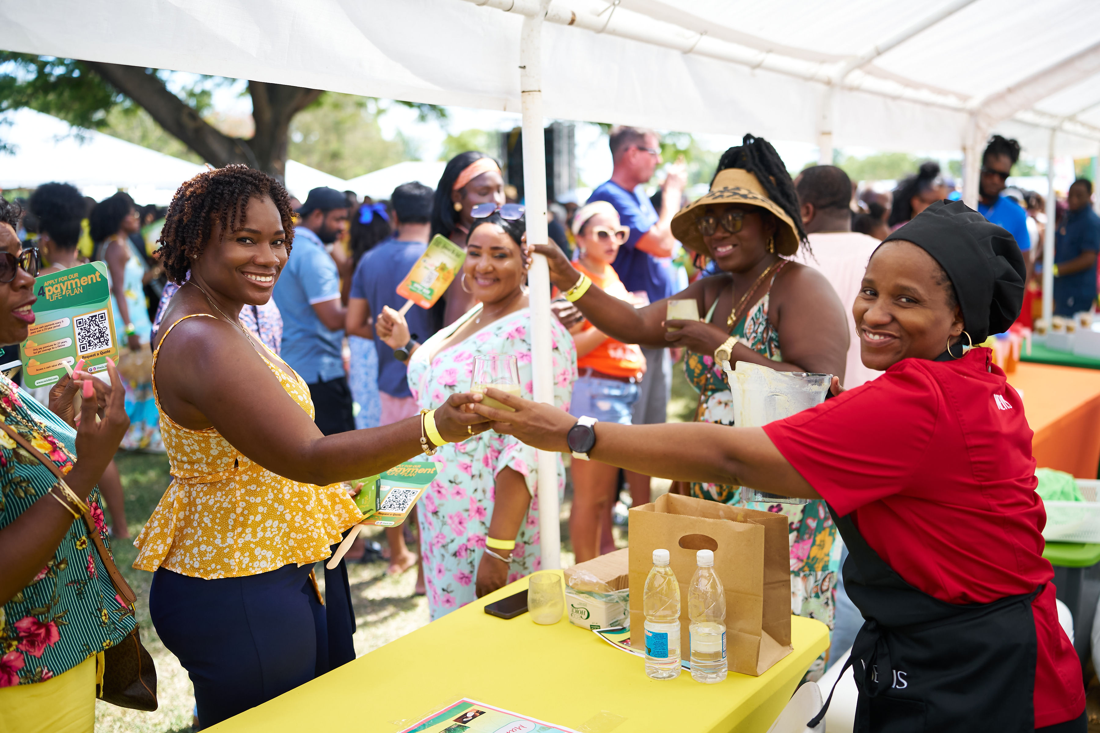 Guests enjoying mango tastings and drinks at Nevis Mango Festival outdoor event