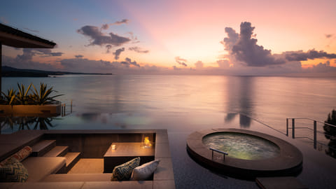 Private terrace with infinity pool and hot tub overlooking ocean at sunset