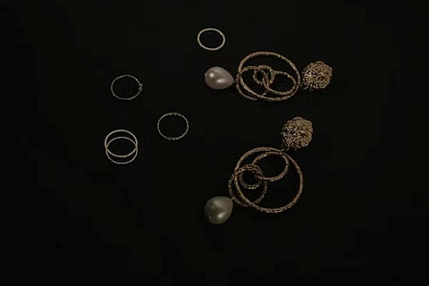 gold-tone earrings with interlocking hoops and pearl drops