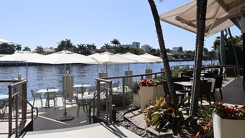 Outdoor waterfront patio with umbrellas and seating along the Intracoastal Waterway