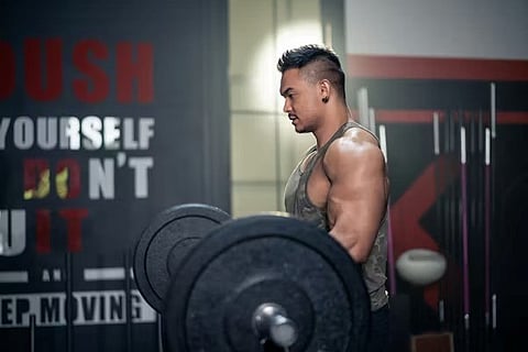 a person engaging in strength training with a barbell