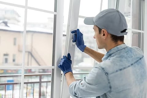 a professional contractor installing new white vinyl windows