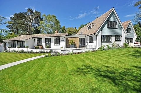 a modern detached residential property with a landscaped lawn