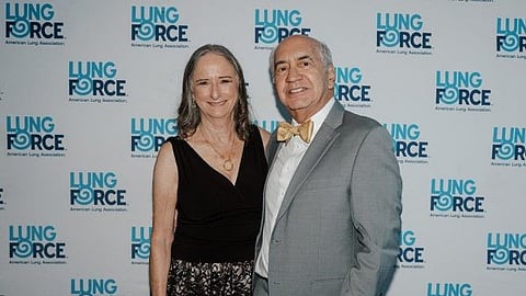 Dr. Caren Singer and Dr. Glenn Singer pose at the LUNG FORCE Sunset Soirée gala backdrop