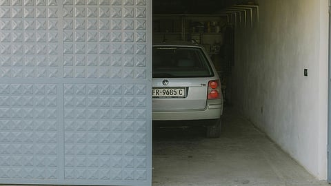 a residential or small commercial garage with a modern, light blue sliding door