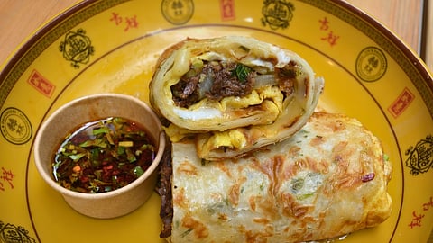 Scallion pancake breakfast wrap with eggs, beef, and chili oil at Lin & Daughters