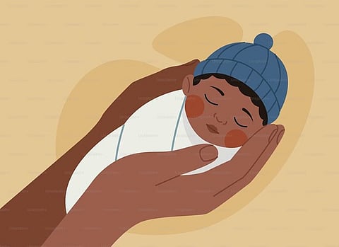 a vector illustration of a newborn baby in a blue beanie being held