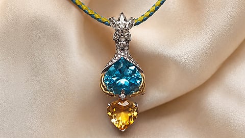 Blue and yellow gemstone pendant with diamond accents inspired by a Ukrainian family reunion