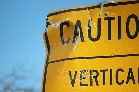 a damaged yellow caution sign