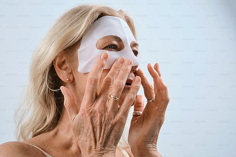 a sheet mask being applied
