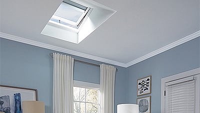 a modern living room interior featuring a VELUX skylight installed in the ceiling