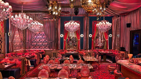 Opulent Habibi dining room with chandeliers, rich textiles and Moroccan-inspired decor