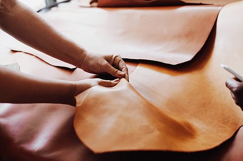 person working on a leather fabric