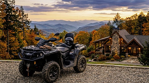 ATV parked beside a luxury mountain cabin overlooking the Great Smoky Mountains at sunset