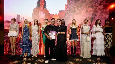 Jhoan Sebastian Grey poses with his award alongside models at the Virtual Fashion Awards ceremony