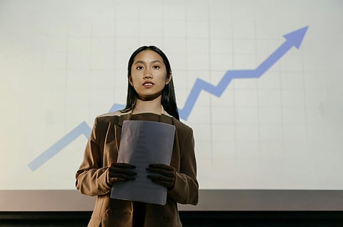 a professional girl in coat giving presentation