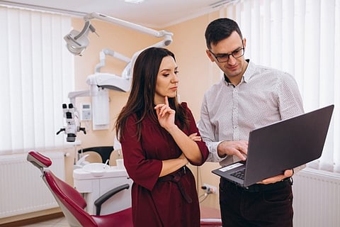 a consultation in a modern dental office featuring advanced imaging equipment