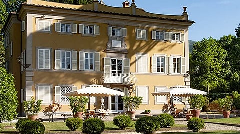 Historic Tuscan villa surrounded by manicured gardens in the countryside near Lucca
