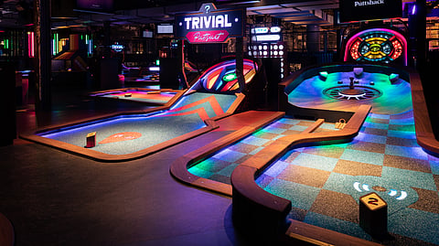 Neon-lit mini golf courses inside Puttshack Miami at Brickell City Centre