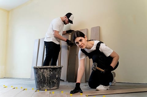 two individuals engaged in a home renovation project