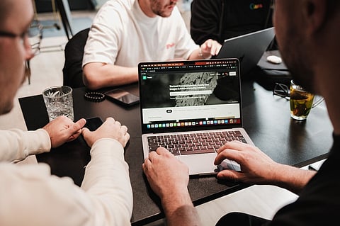 a team collaborating on a project using laptops